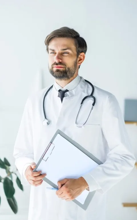 Medical professional holding a clipboard, symbolizing guidance